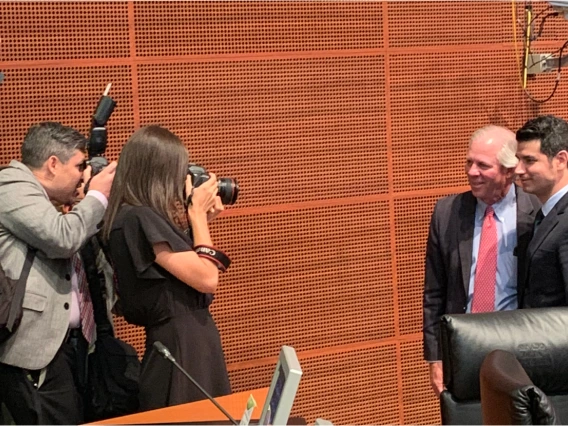 President Robbins addresses an audience at a podium while in Mexico City