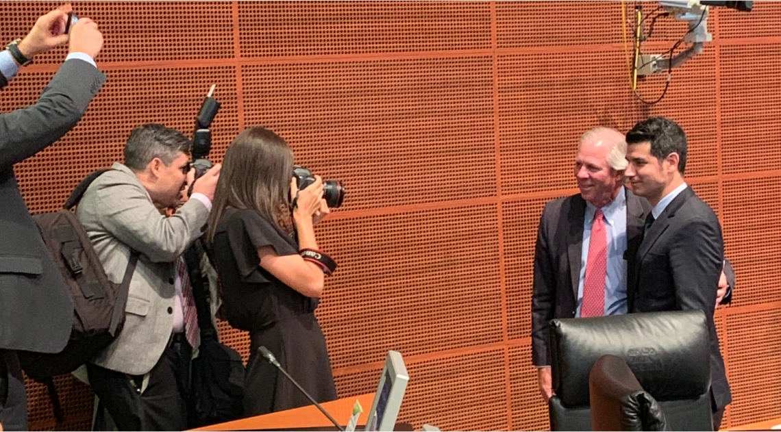 President Robbins addresses an audience at a podium while in Mexico City